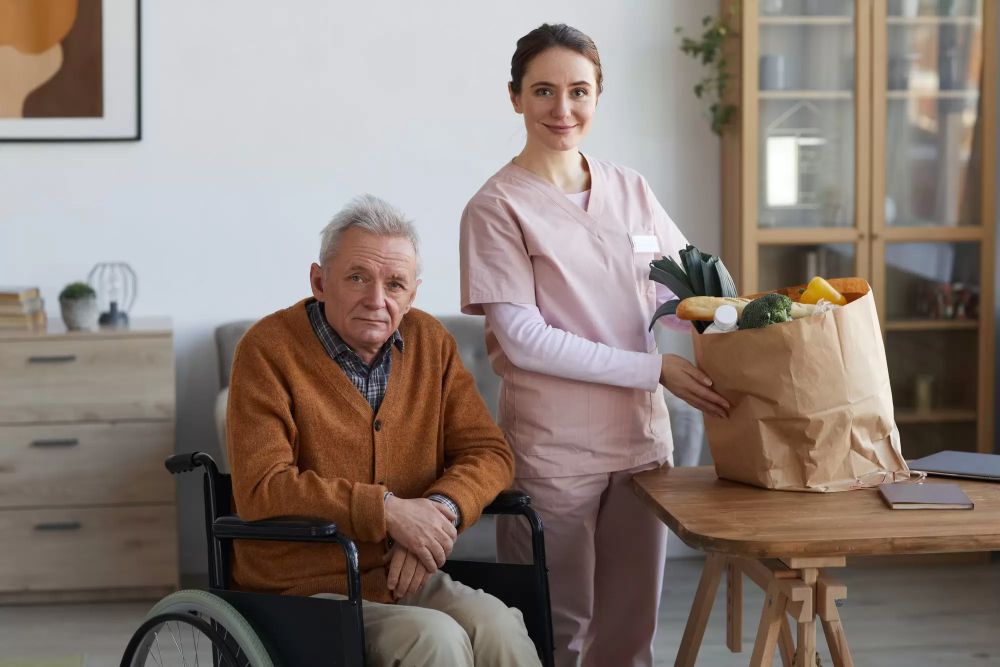 Portrait Of Disabled Senior Man With Female Caregiver