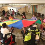 Brochure - Group playing parachute (1)